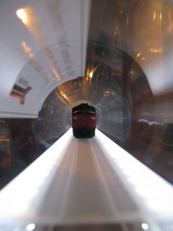 On-board Amtrak's Exhibit Train - Lined up inside a clear tube is one of the scale model trains depicting how an Amtrak train looked in the early 1970's.