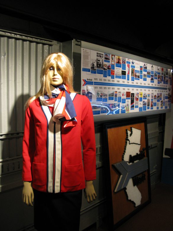 On-board Amtrak's Exhibit Train - A model displaying one of Amtrak's earliest uniforms that debuted in 1972.  Behind the model is a timeline of Amtrak milestones throughout the years.