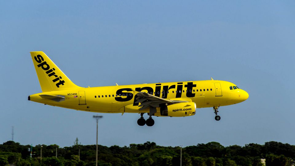 Yellow Spirit jet against a blue sky.