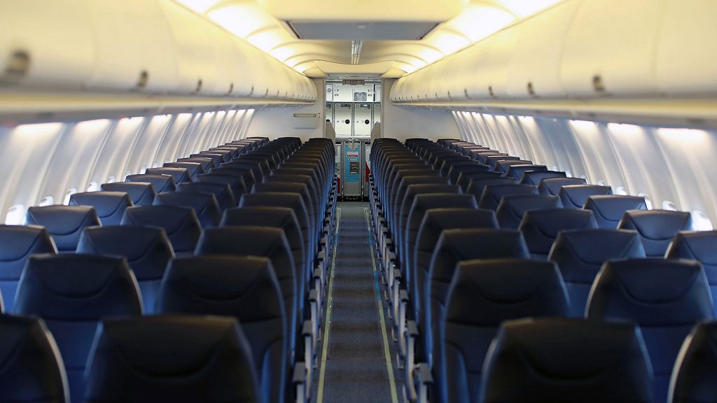 Plane interior with blue seats.